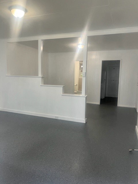 an empty room with a staircase and a door